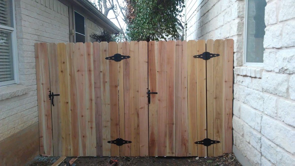 Double wood gate with black hinges and latches
